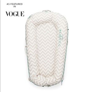 The DockATot Deluxe+ dock. Chevron Gray and white.